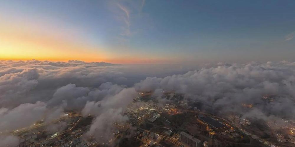 Sunset in Aseer: A Breathtaking Tableau of Clouds and Mountain Peaks